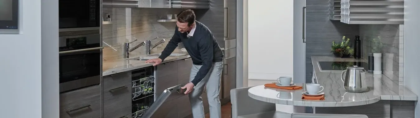 Man opening dishwasher